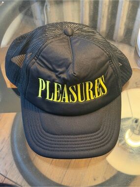 PLEASURES Black Trucker Hat with Yellow Logo